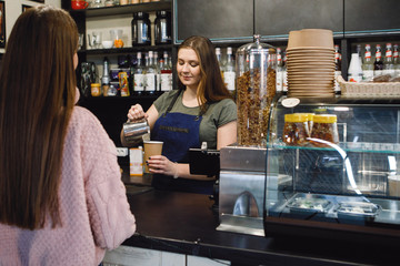 Barista woman in the bar.