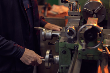 Close-up of worker working with special equipment in the factory