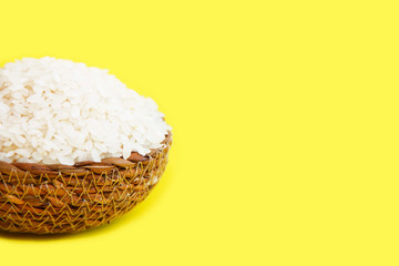 natural white rice in a decorative plate on a yellow background