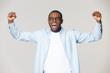 Excited african american young man celebrating favorite sport team win.