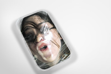 Heavy. Human head as a goods in plastic box on white background, ecology concept. We're selling our...