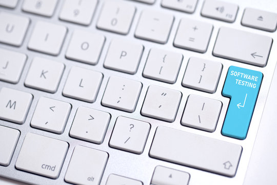computer keyboard with highlighted enter-key and the words "software testing" on it