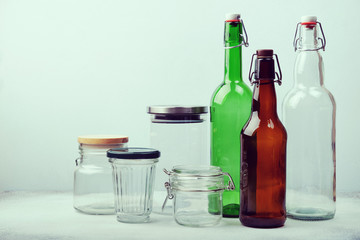 Reusable glass bottles and jars on table. Sustainable lifestyle. Zero waste grocery shopping and storage concept