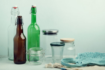 Obraz premium Eco bags, reusable glass bottles and jars on table. Sustainable lifestyle. Zero waste grocery shopping and storage concept
