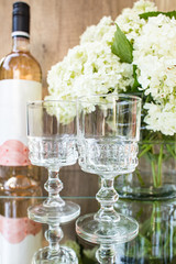 Rose blush wine in glasses. Bottle of rose wine with flowers on background. Prosecco.