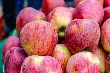 A bunch of whole ripe apple in fruit market 