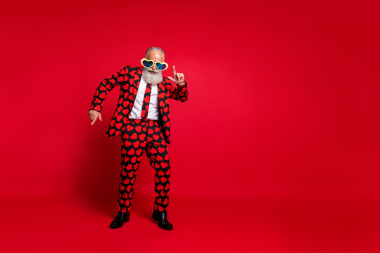 Full length photo of funky aged man amour cupid character role play dancing corporate party wear sun specs hearts pattern suit costume isolated vibrant color background