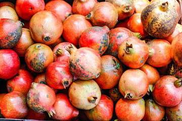 A bunch of whole ripe pomegranates.