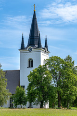 Fototapeta na wymiar The beautiful white church in Svardsjo in Sweden in summer sunlight