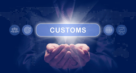Businessmans cupped hands holding a Customs business concept on a computerised display.
