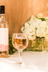 Rose blush wine in glasses. Bottle of rose wine with flowers on background. Prosecco.