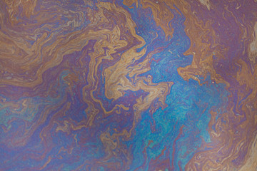 Gasoline stain on the pavement. Beautiful multi-colored blots.