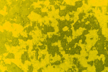  Bright abstract texture of wet plaster on the wall, yellow color and its shades.