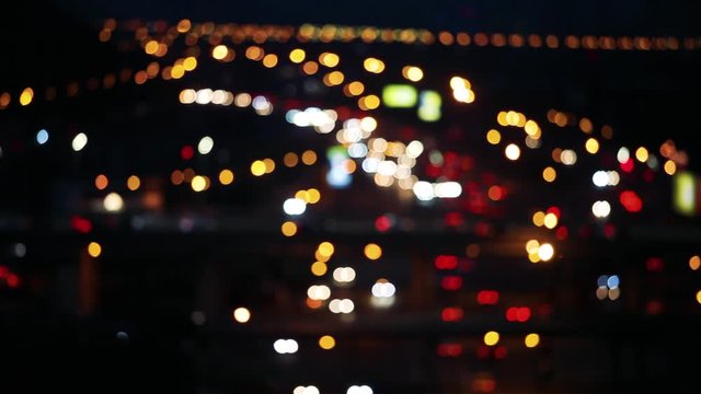 Defocused night city car traffic lights. Color blurred bokeh of moving transport and typical city view