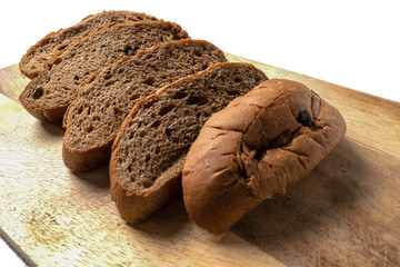 chocolate cut into slices on a wooden chopping board with a bread knife