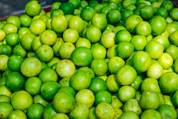 Green and yellow lemon in indian vegetable market 