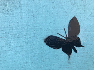 Artificial Black butterfly on blue background