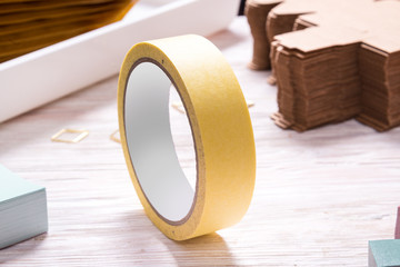 Yellow  tape roll  on wooden office table