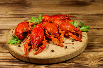 Boiled crayfish on cutting board on wooden table