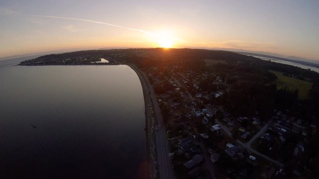Breathtaking Aerial Background of Golden Sunset Over Coastal Town
