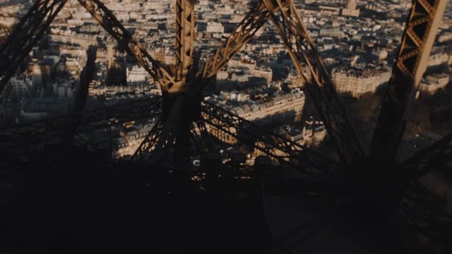 Beautiful cinematic background view, camera inside Eiffel tower, Paris, is moving down on elevator among steel structure