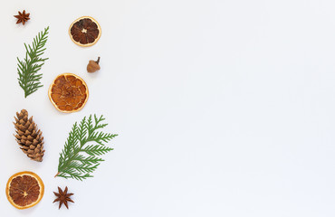 Fir twigs and star anise, tree cone with dry citrus on a white background, Christmas holiday background, flat lay, copy space