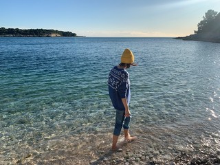 Young girl walking by the sea, winter style