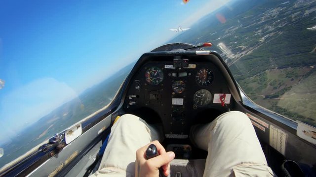 POV of pilot flying small private jet or glider