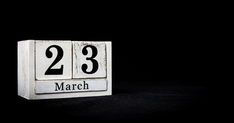 March 23rd, Twenty-third of March, Day 23 of month March - white calendar blocks on black textured background with empty space for text.