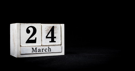 March 24th, Twenty-fourth of March, Day 24 of month March - white calendar blocks on black textured background with empty space for text.