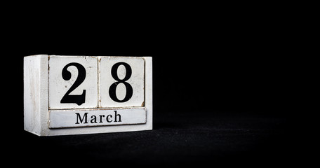 March 28th, Twenty-eighth of March, Day 28 of month March - white calendar blocks on black textured background with empty space for text.