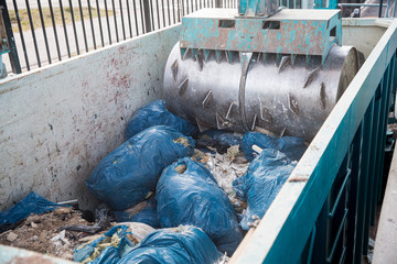 Special equipment is pressing construction waste in a container for recycling on Sorting station