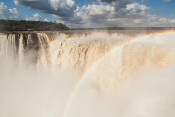 Rainbow over the waterfall, sunny day