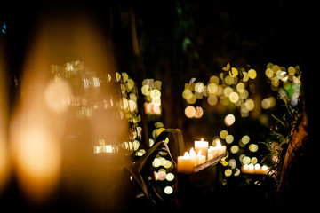 Attractively lit green tropical garden with candles and lights