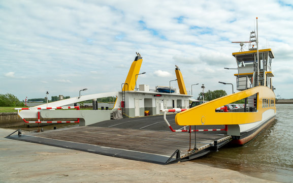 Ferry across the Lek near city of Schoonhoven, the Netherlands. Roll-on roll-off Boat transporting cars and people over the river Lek to the other side.