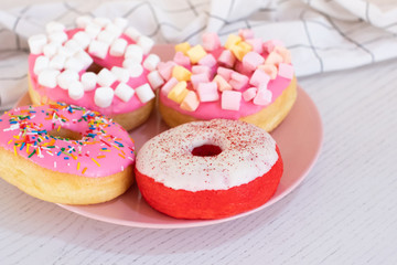 Colorful donuts on the table. close up view. copy space