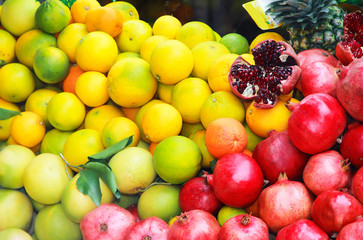 natural fresh fruits yellow lemons, oranges and red pomegranates