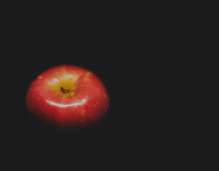 Red apple on black background