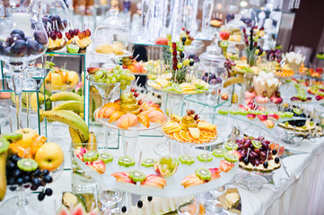 Dessert table of delicious fruits on wedding reception.