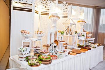 Dessert table of delicious snacks on wedding reception.