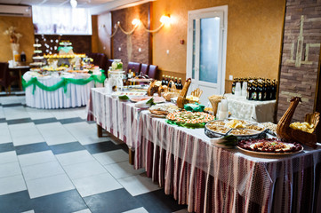 Fototapeta na wymiar Dessert table of delicious snacks on wedding reception.