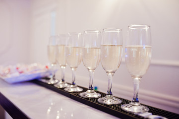 Dessert table of champagne glasses on wedding reception.
