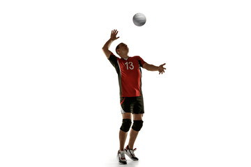 Young caucasian volleyball player placticing isolated on white background. Male sportsman training...