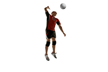 Young caucasian volleyball player placticing isolated on white background. Male sportsman training with the ball in motion and action. Sport, healthy lifestyle, activity, movement concept. Copyspace.