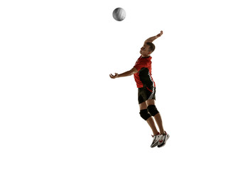 Naklejka premium Young caucasian volleyball player placticing isolated on white background. Male sportsman training with the ball in motion and action. Sport, healthy lifestyle, activity, movement concept. Copyspace.