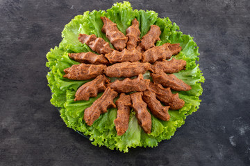 Cig kofte (raw meatball in Turkish) with lettuce, tomato, pickle and lemon, hot Chee kofta