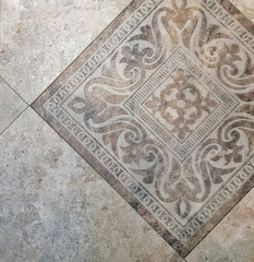 Light ceramic tiles with floral pattern for wall and floor decor. Concrete stone surface background. Texture for interior design project.