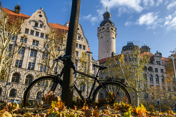 Bicycle parked near a tree around New City Hall Neues Rathaus in historical part of Leipzig,...