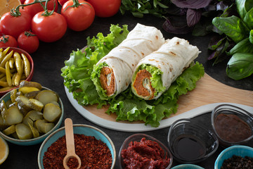 Cig kofte (raw meatball in Turkish) with lettuce, tomato, pickle and lemon, hot Chee kofta
