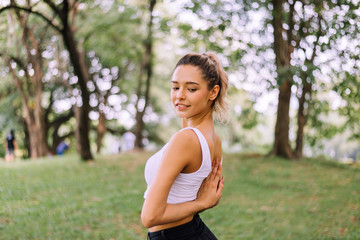 Happy young woman doing or practicing yoga at park in the morning,Relaxing time,Meditation concept